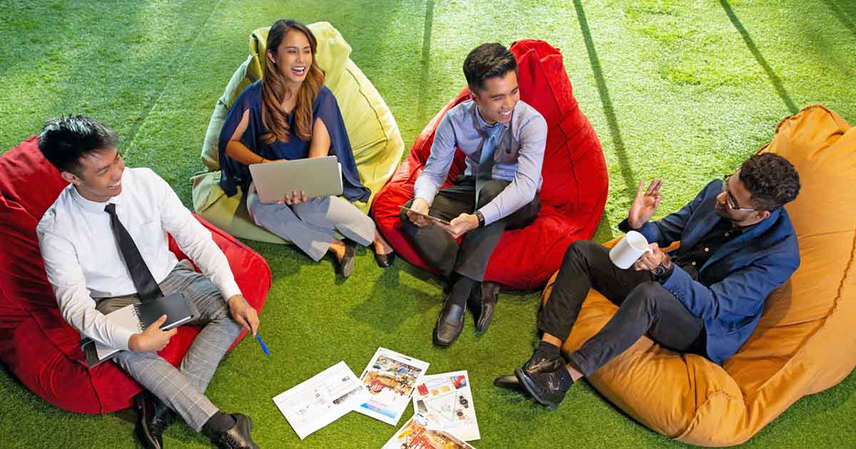 Sunway employees learning and working together at Sunway iLabs, discussing over a laptop2