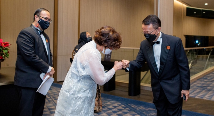 A medium full landscape shot of Sunway Group founder and chairman Tan Sri Dr. Jeffrey Cheah AO sharing a fist bump with Malaysian AIDS Foundation chairman Professor Dato’ Dr. Adeeba Kamarulzaman