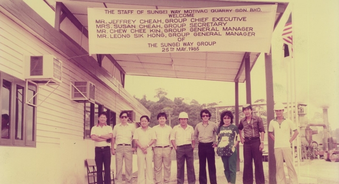 A sepia photo of the first office of Sunway Group – a small warehouse with a simple signage of the staff of Sunway