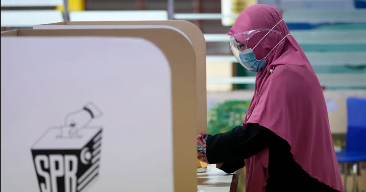Candid shot of Malaysian woman casting her vote