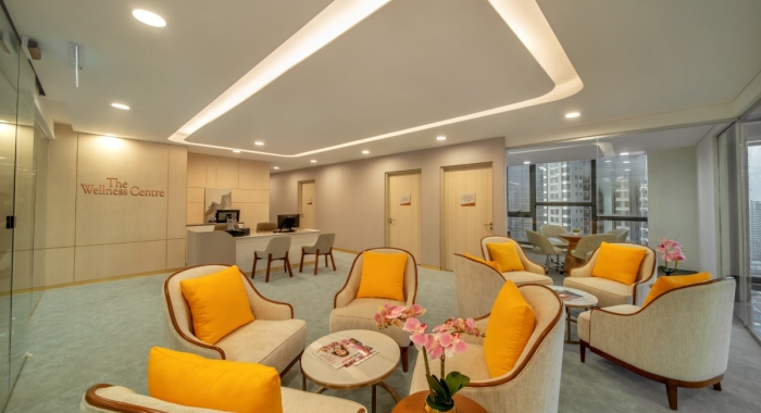 A view of Sunway Sanctuary’s living space, filled with sofas and yellow-coloured pillows