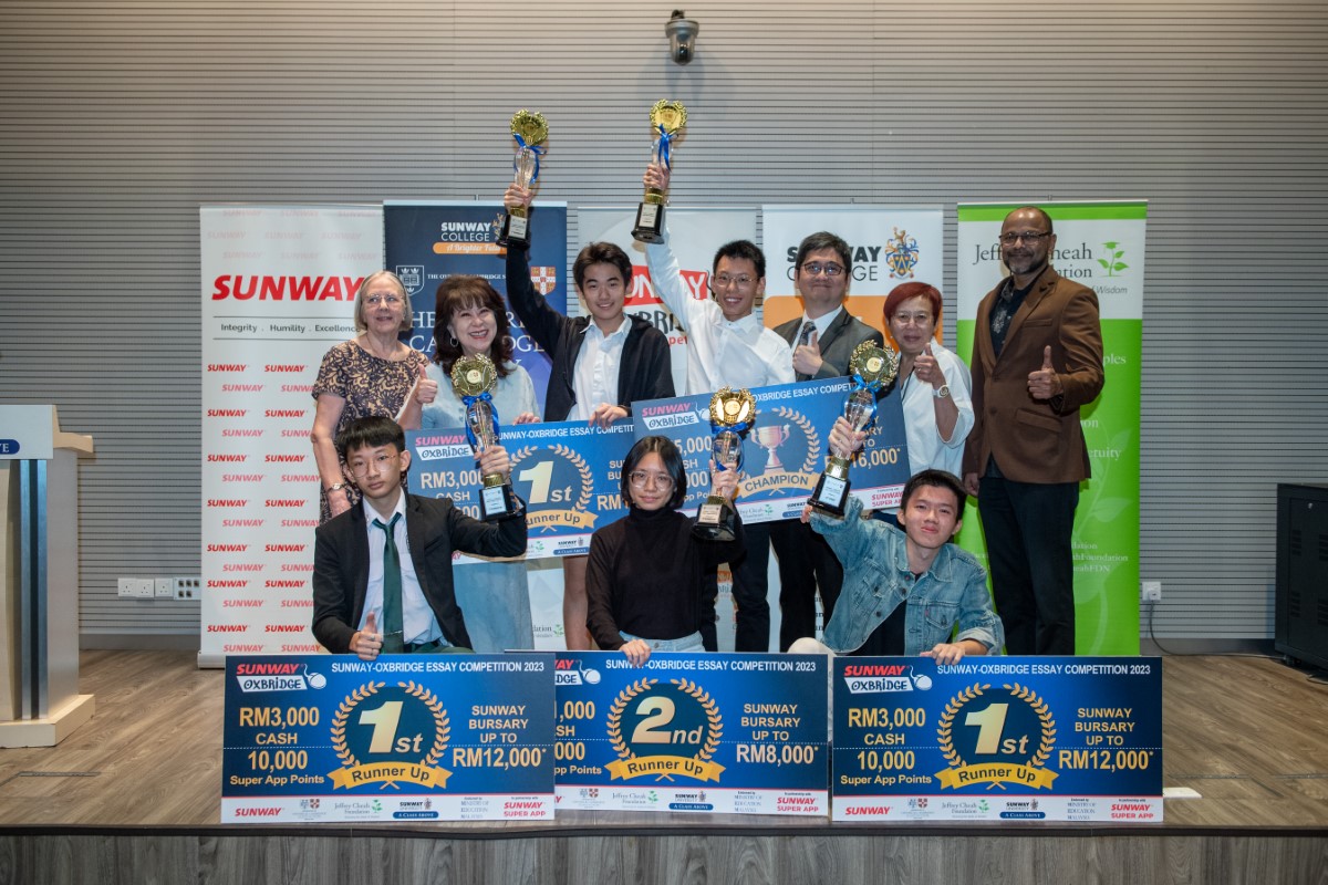 Students and their prizes at a prize giving ceremony