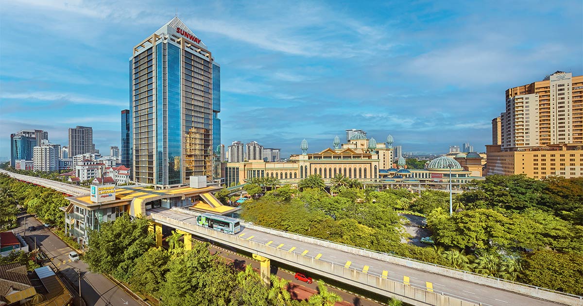A drone shot of Sunway City Kuala Lumpur skyline, with the BRT bus at the front and Sunway Pinnacle in the background