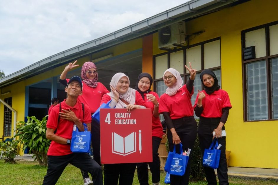 Sunway Volunteers with a Quality Education sign at a CSR event