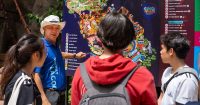 A Sunway Senior Park Ambassador (SPA) is showing guests at Sunway Lagoon the park map.